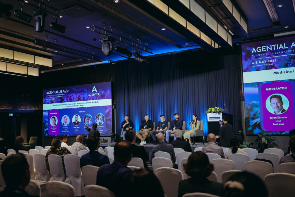 Industry leaders speaking on a panel during an Agential Cannabis conference in Bangkok, with an audience attending a session on medicinal cannabis markets