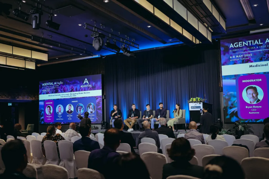 Industry leaders speaking on a panel during an Agential Cannabis conference in Bangkok, with an audience attending a session on medicinal cannabis markets